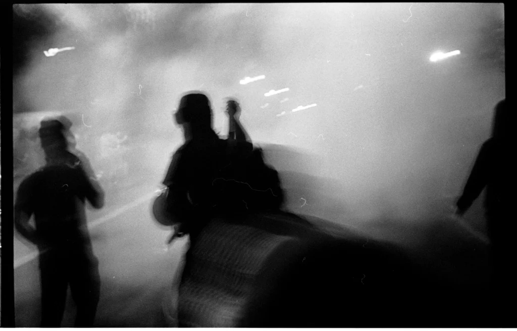 Tear Gas a photograph by Chris Cook of figures moving through tear gas during a black lives matter protest